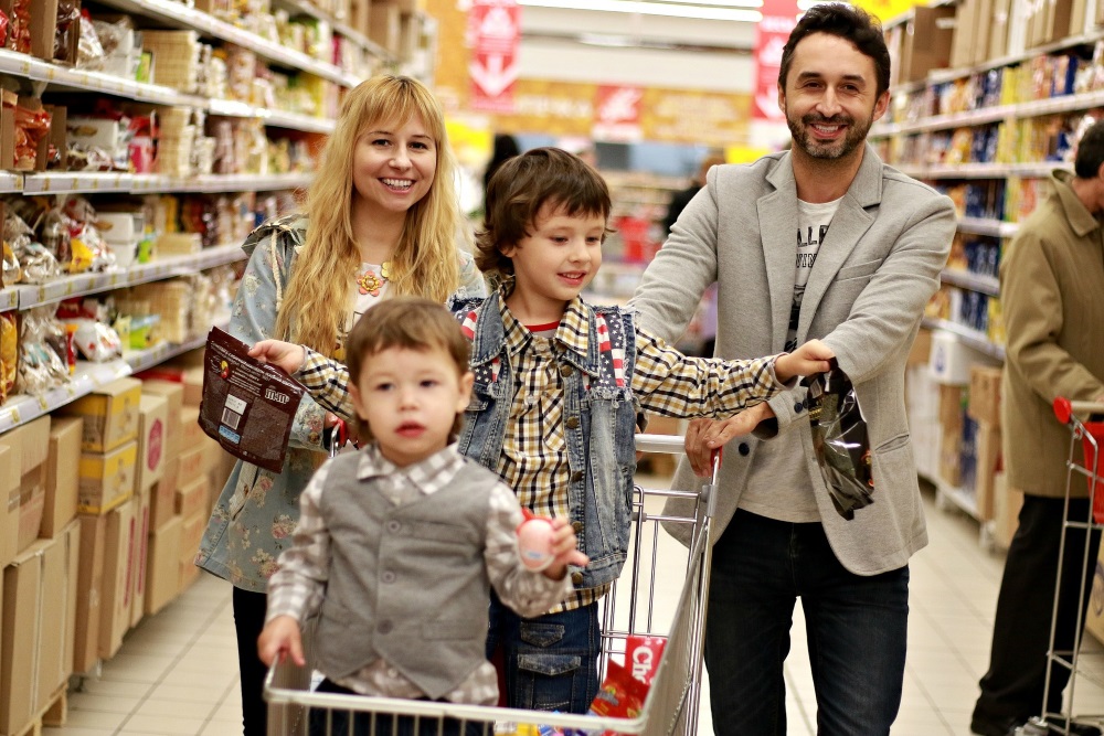 happy family shopping for food in a supermarket